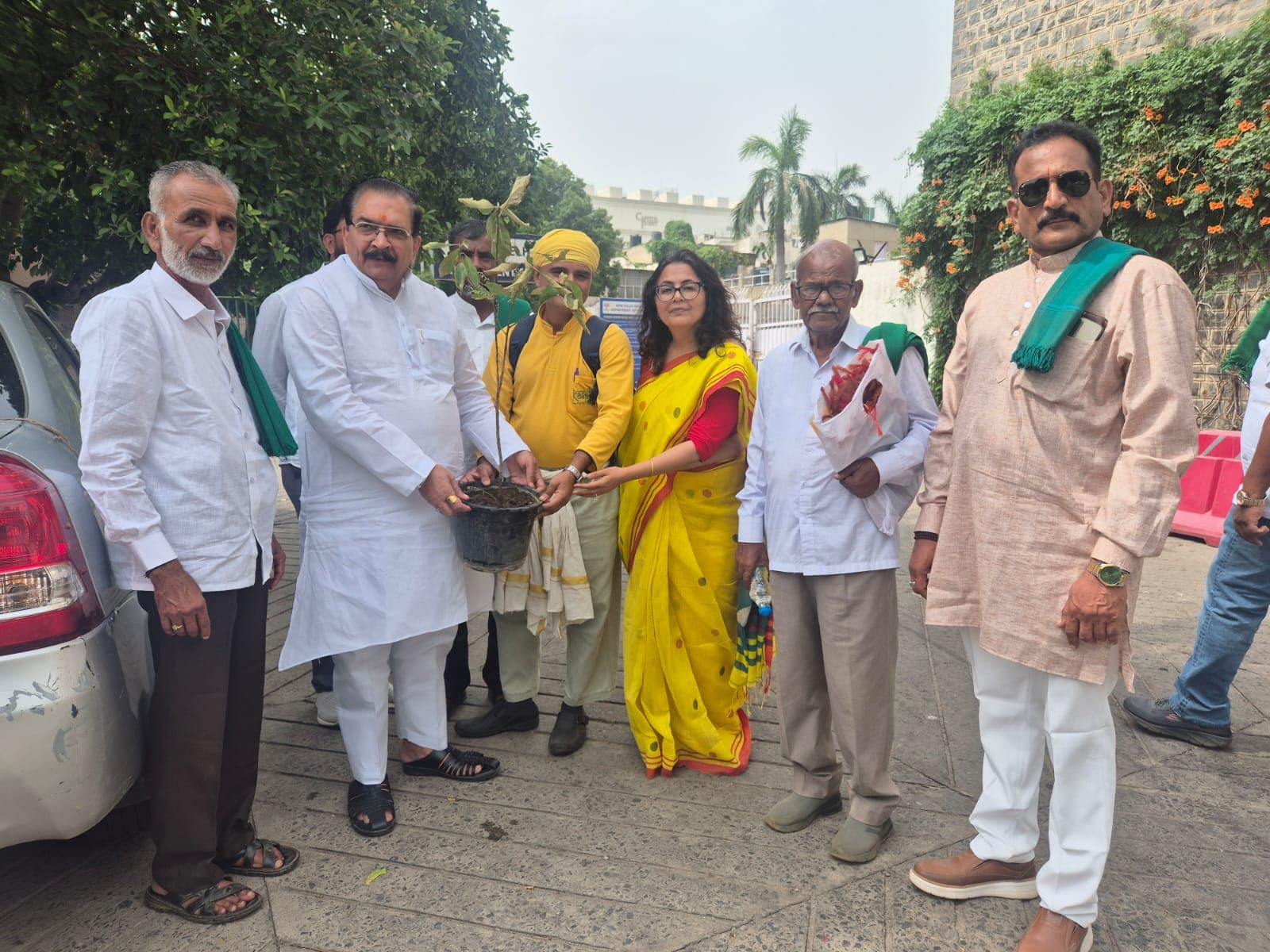 Mahacharya Sourabh J. Sarkar presenting a plant to শ্রী কৃষ্ণ বীর চৌধুরী with BKS representatives